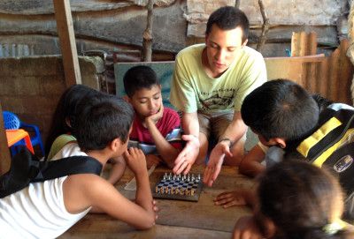 Volunteer Sean teaching the kids how to play chess